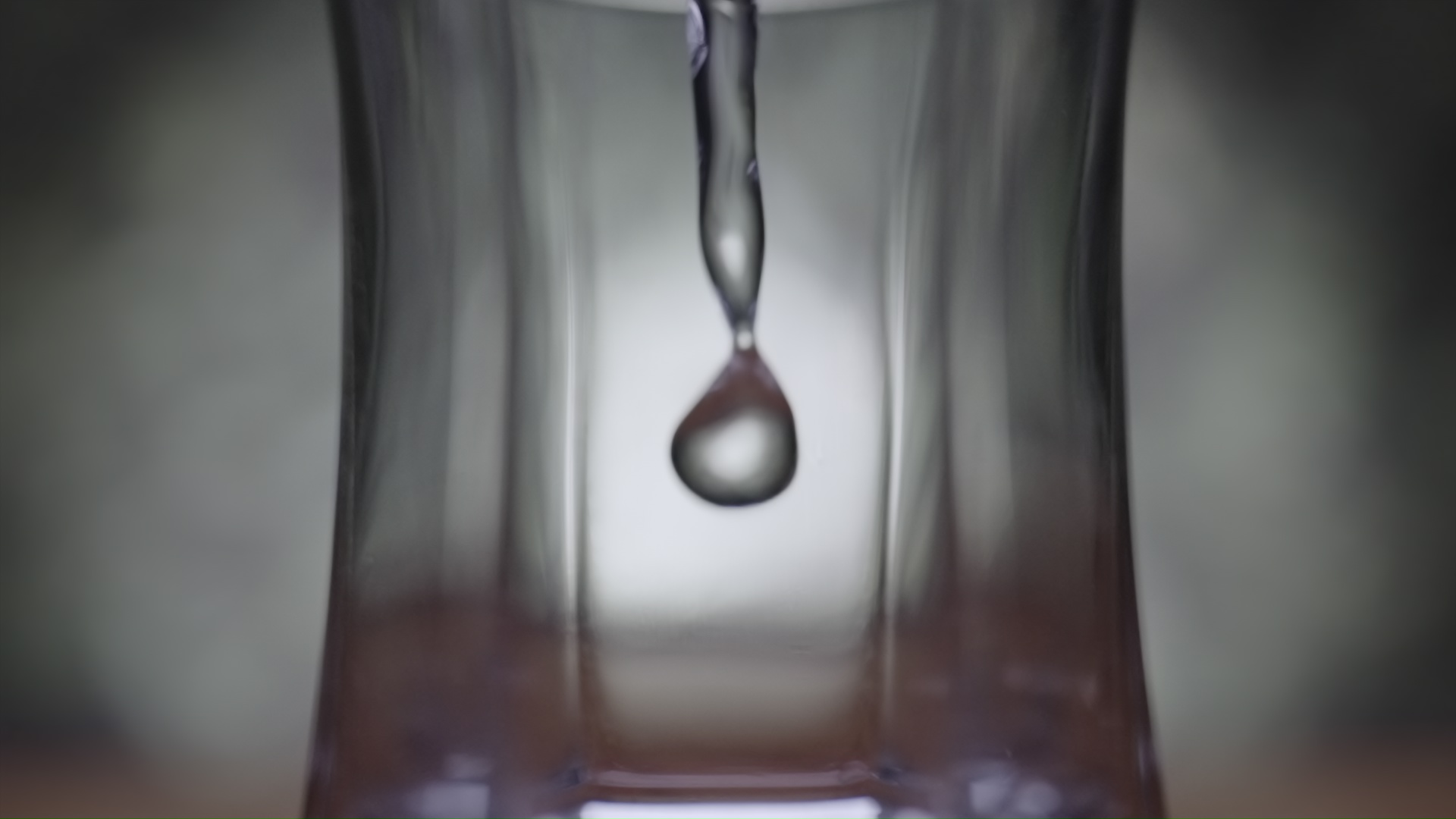 Macro of water poured into the glass