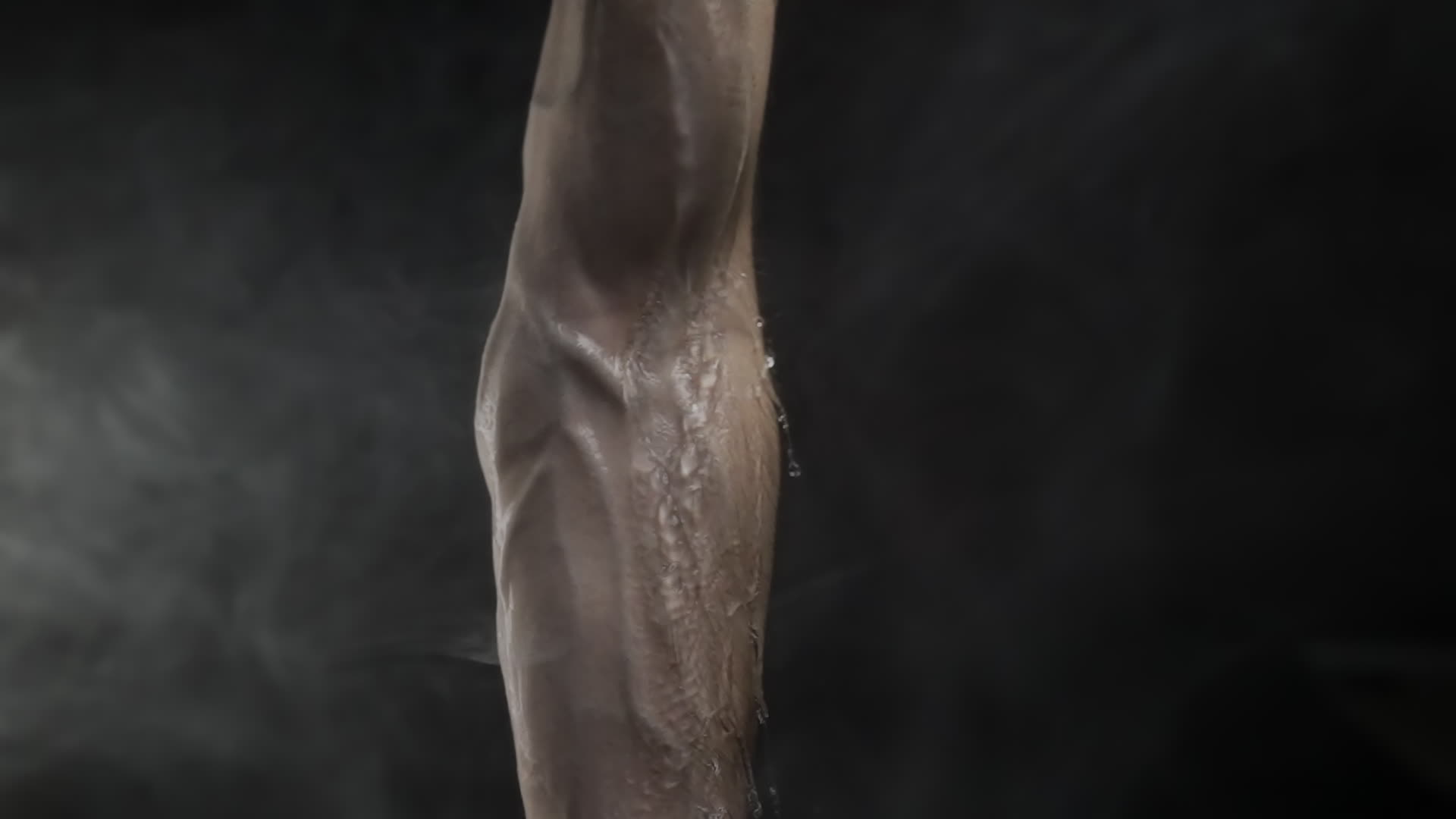 Muscular Arm with Water Running Down