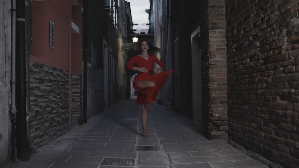 Dancer in Red Twirling Down an Alley